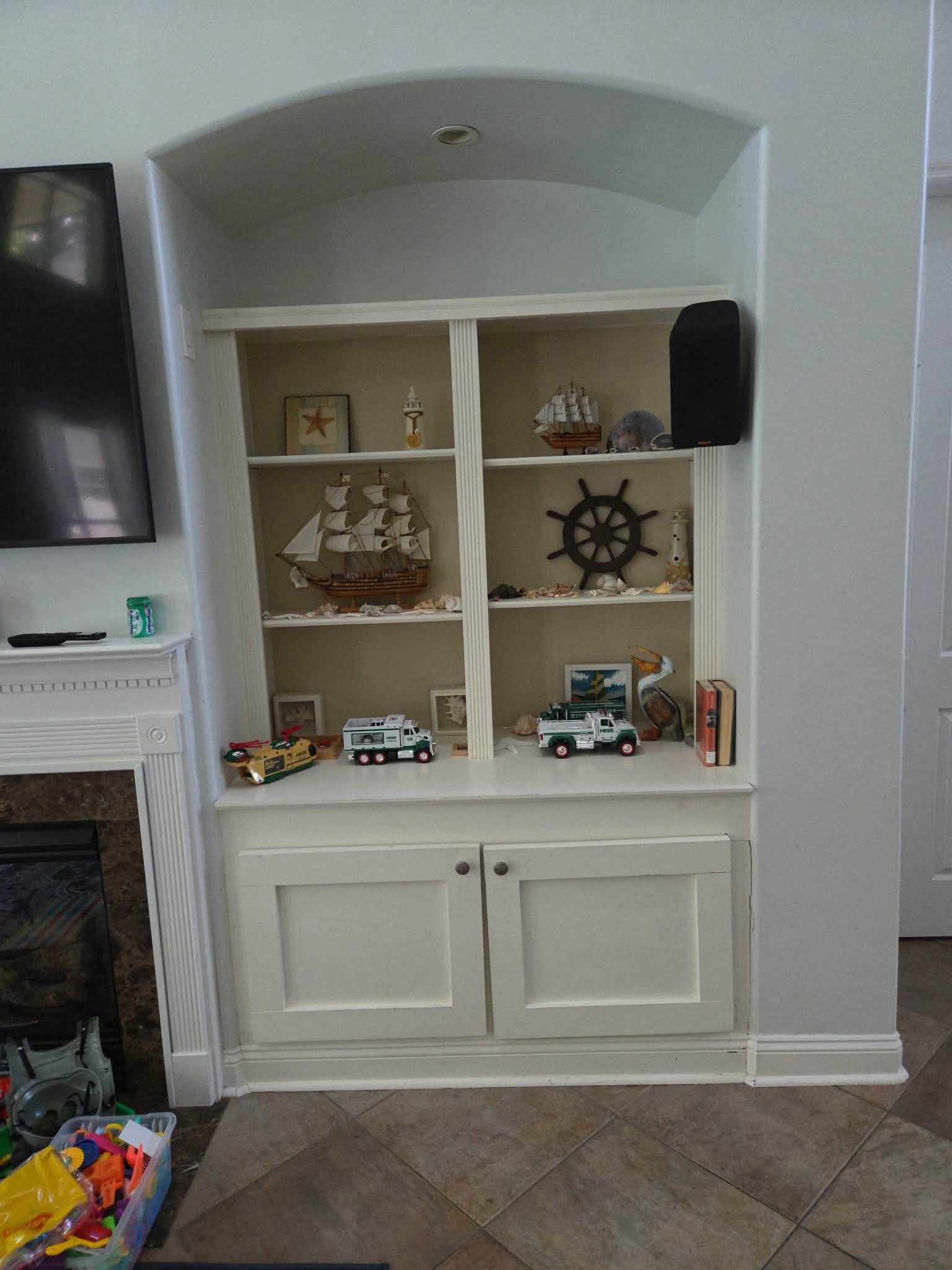 Cabinet and shelving detail of a media-wall project published by McGrath Handyman Services